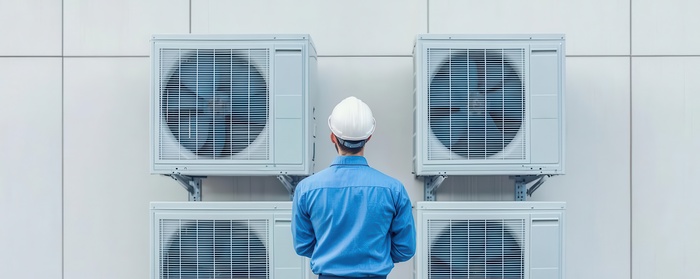 Repairman performing routine maintenance and repair on HVAC